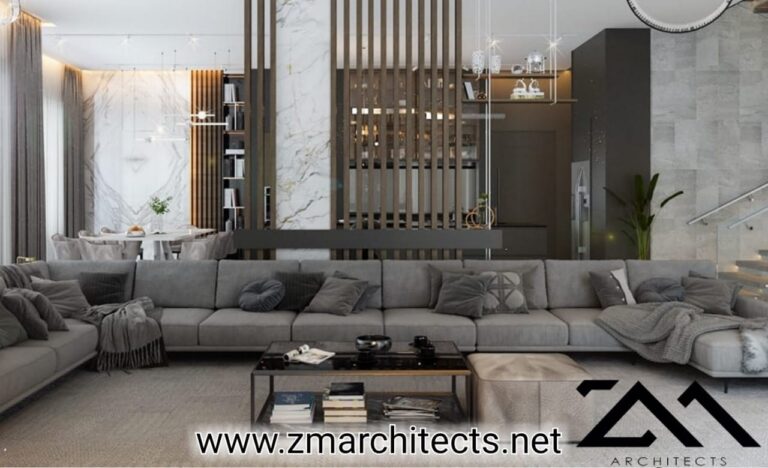 A contemporary living room with a sectional sofa and marble flooring, designed by ZM Architects.
