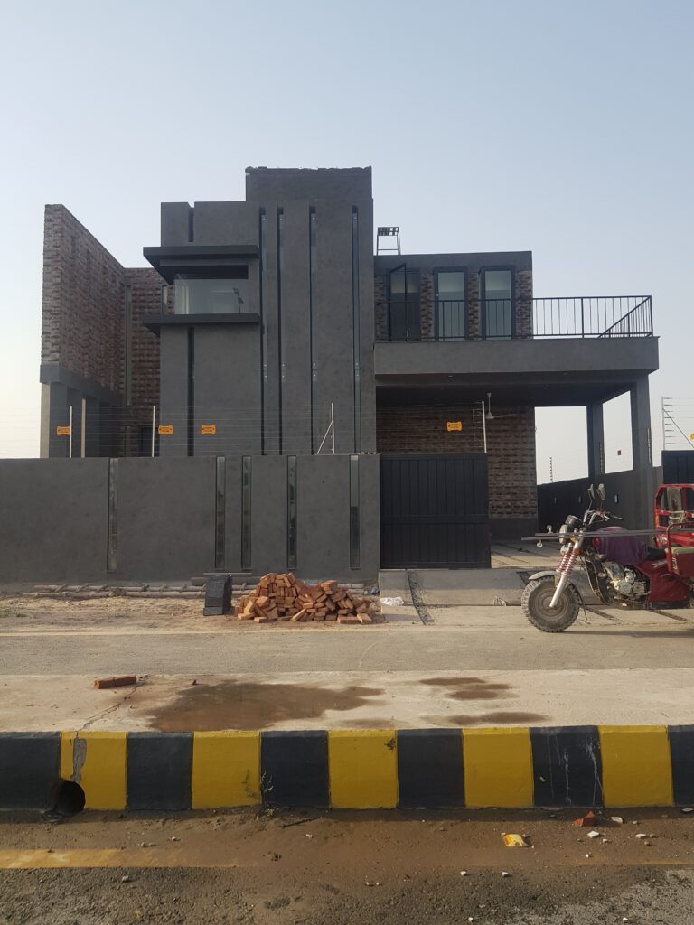 Construction-stage view of a custom residence in Lahore, showing the structural facade prior to finishing. Documented by ZM Architects.