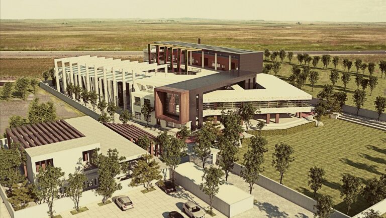 An aerial masterplan view of the First Steps school campus in Faisalabad, organized around a colonnaded courtyard and landscaped grounds. Designed by ZM Architects.