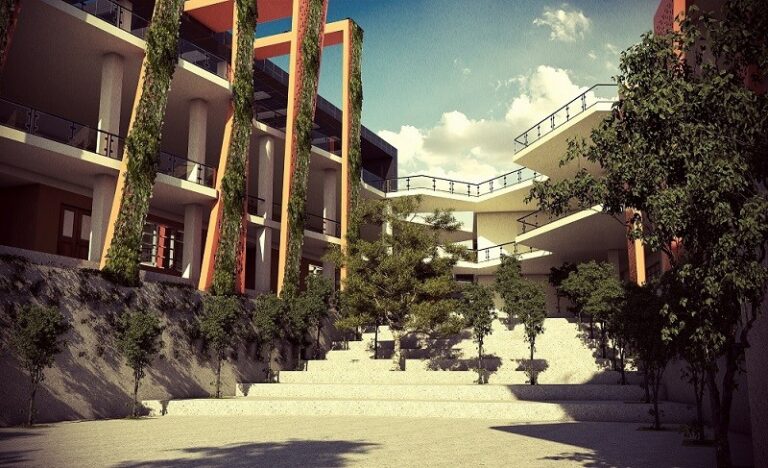 A landscaped courtyard at the heart of a modern school campus in Lahore, framed by planted colonnades and terraced seating. Designed by ZM Architects.