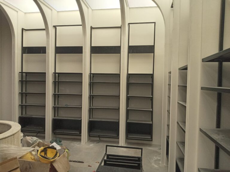 Construction-stage view of the retail shelving fit-out for "My Drug Store" pharmacy in Lahore, documented by ZM Architects.